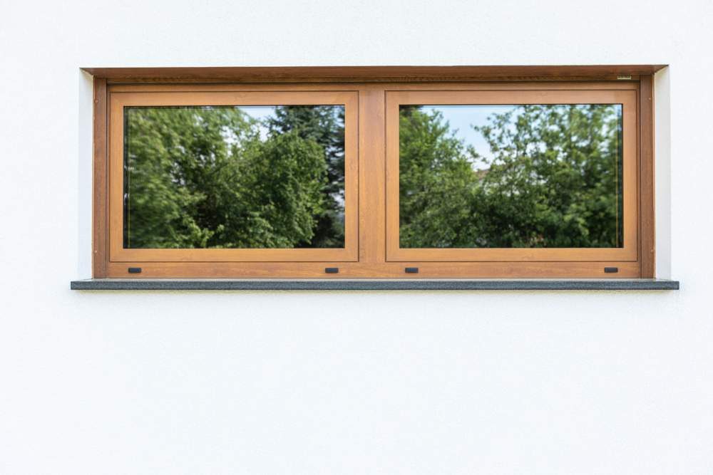 Timber-effect window in a white rendered wall