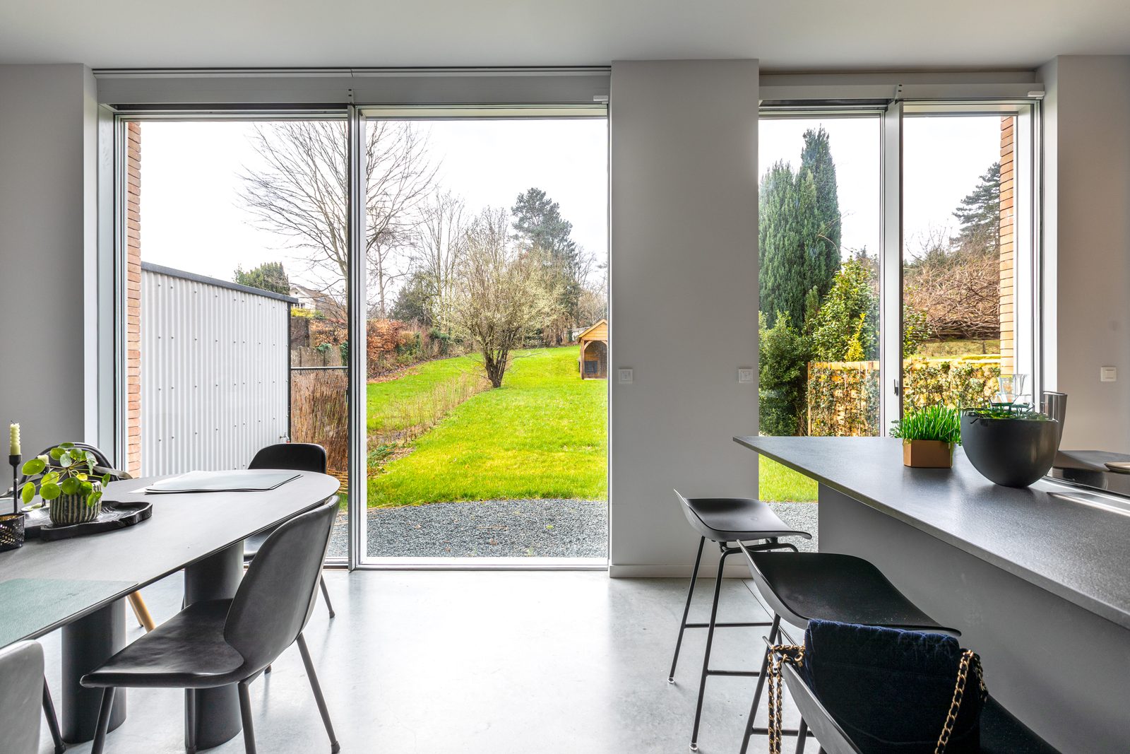 Large sliding glass doors looking onto a garden
