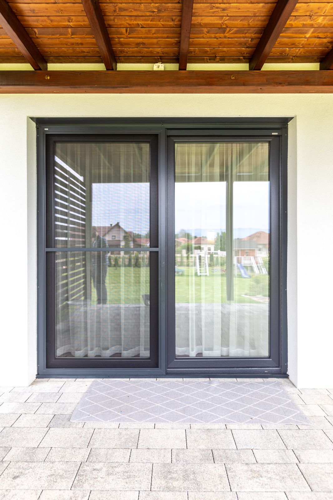 Insect screen fitted over dark double terrace doors